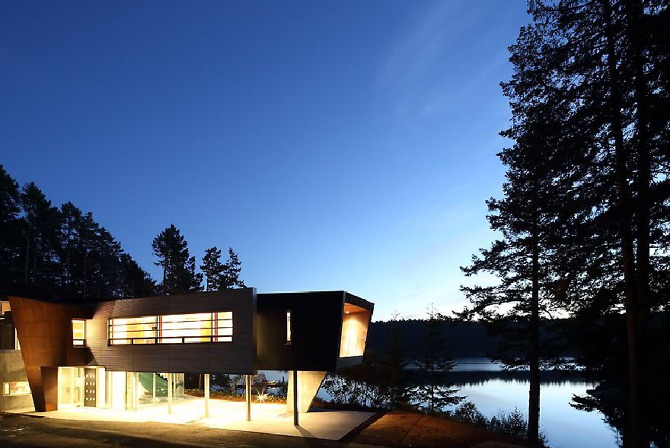 Modern Steel West Coast fusion building exterior at night on Pender Island built by Dave Dandeneau of Gulf Islands Artisan Homes